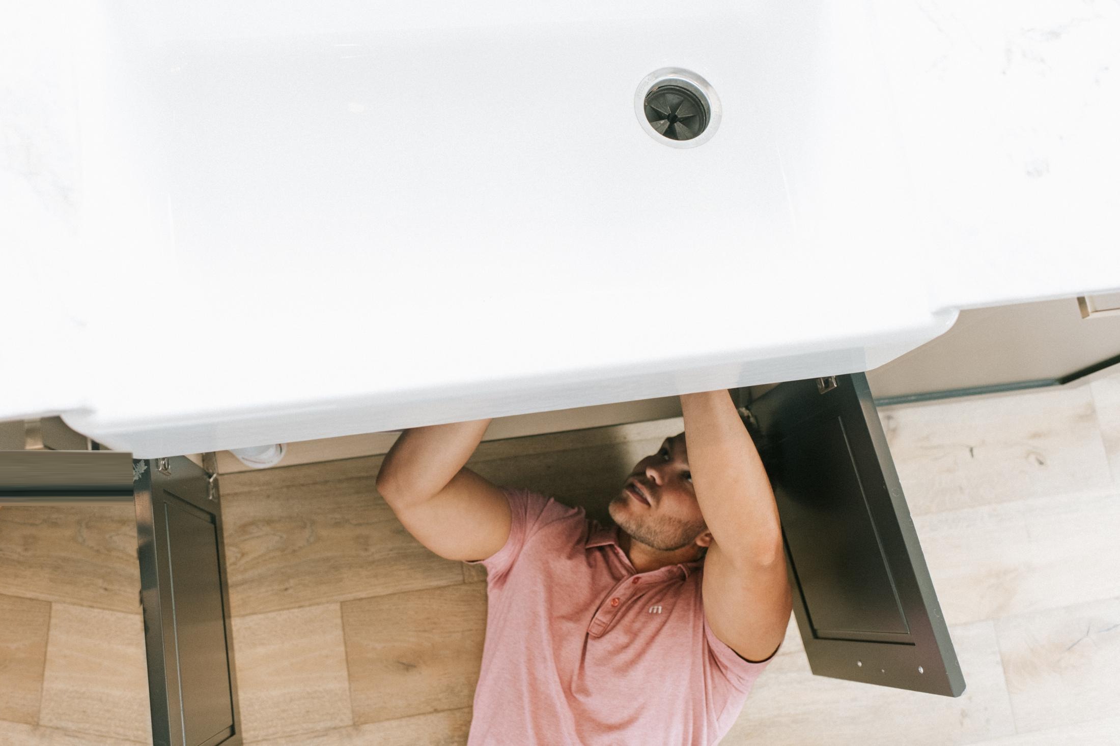 A maintenance repair under a kitchen sink
