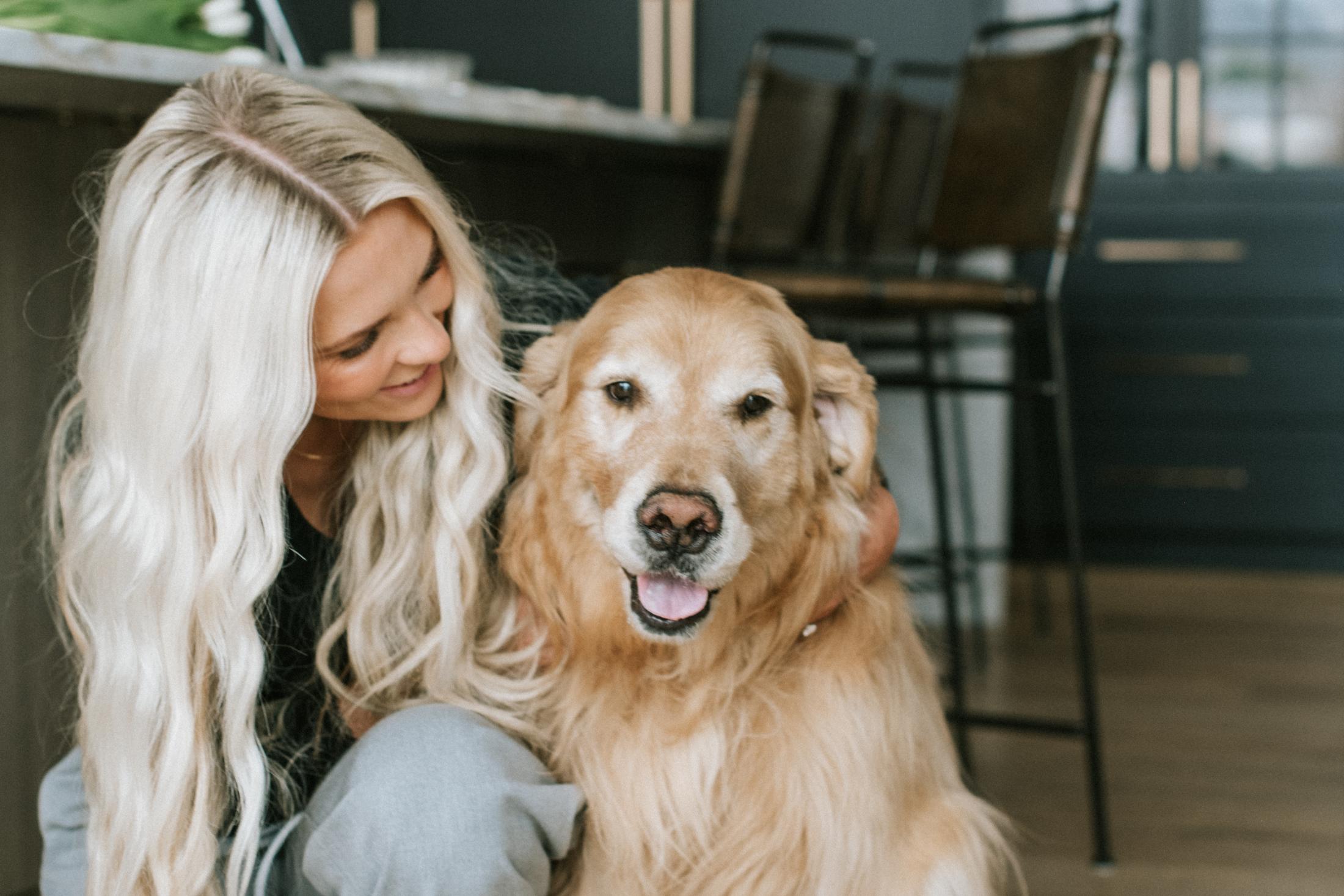 A resident at home with a golden retriever